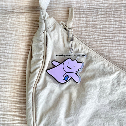 waterproof acrylic keychain with the text “Breaking news: I do not care" on a bag