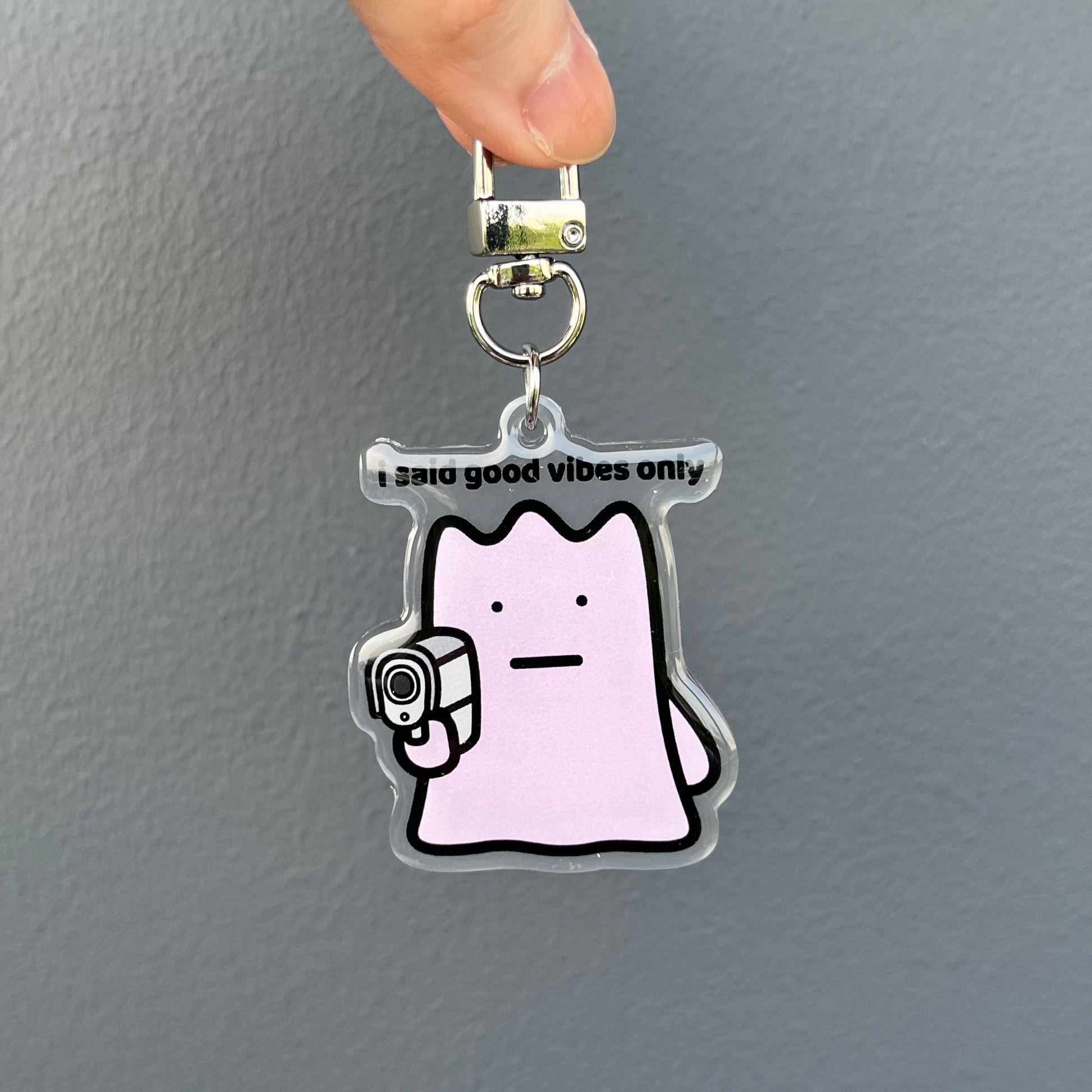 waterproof acrylic keychain with the text “I said good vibes only" on a plain background