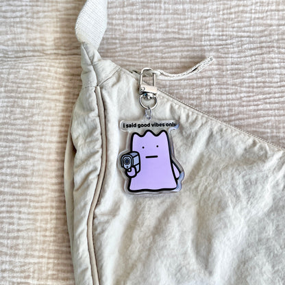 waterproof acrylic keychain with the text “I said good vibes only" on a bag