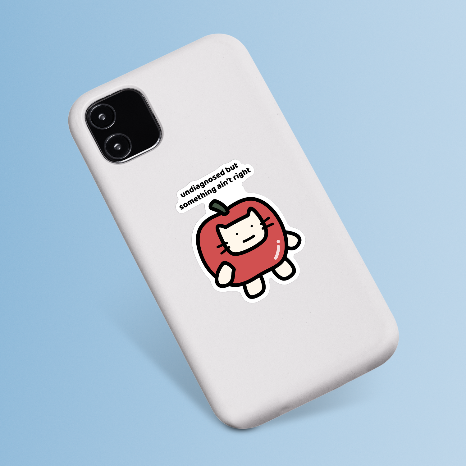 waterproof apple cat vinyl sticker with the text "Undiagnosed but something ain't right" on a phone case