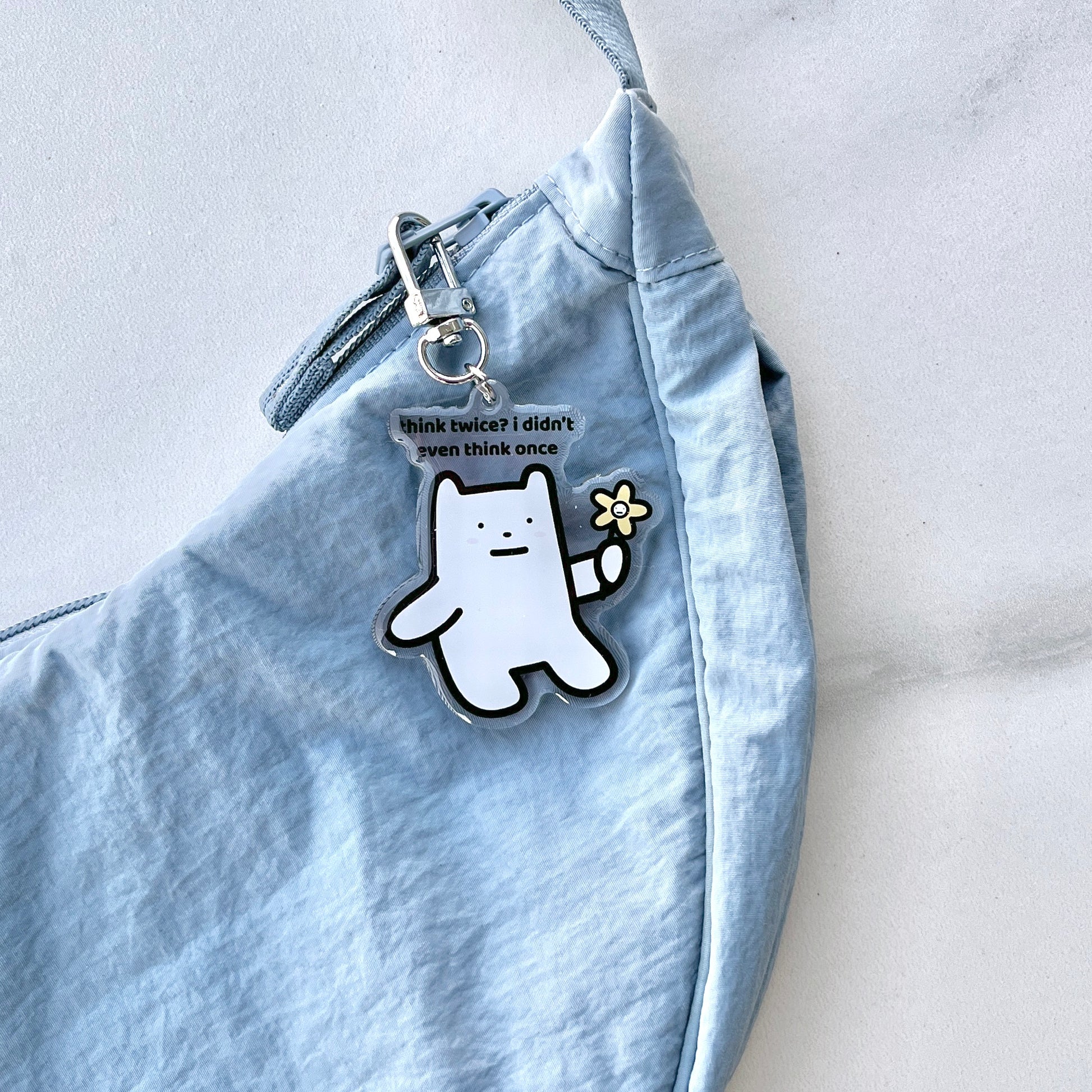 waterproof bear acrylic keychain with the text “Think twice? I didn't even think once" on a bag
