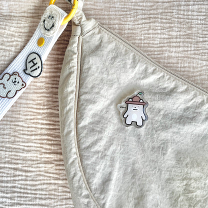 waterproof bear acrylic pin with the text "Yipee" on a bag