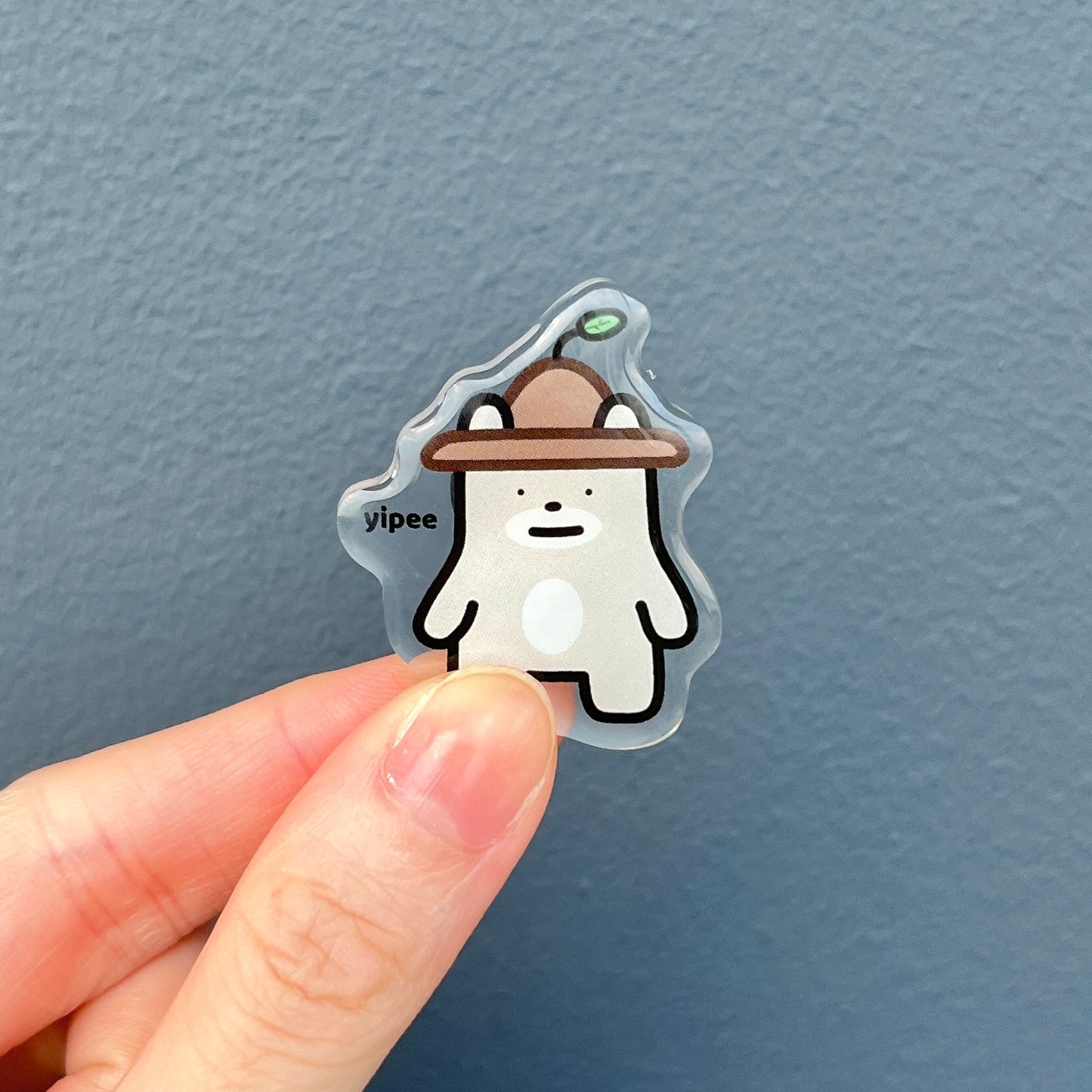 front side of waterproof bear acrylic pin with the text "Yipee"