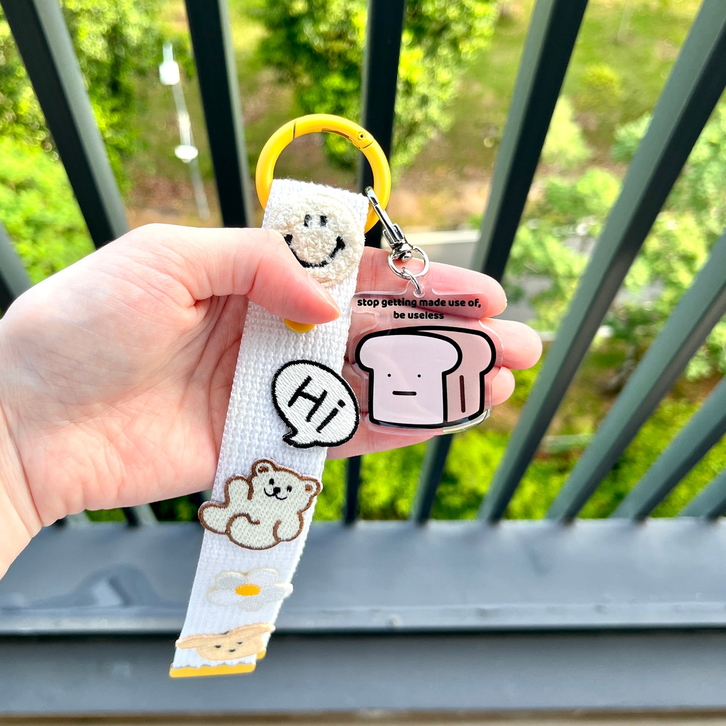 waterproof bread acrylic keychain with the text “Stop getting made use of, be useless" on a person's hand