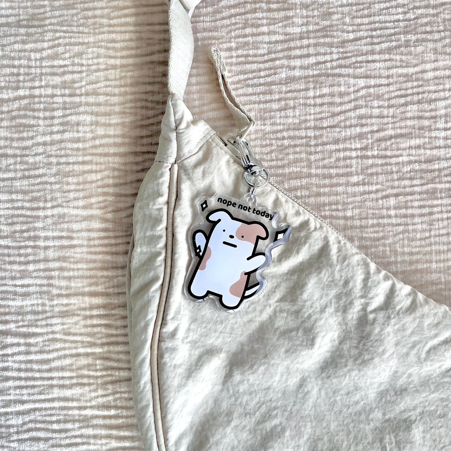 waterproof dog acrylic keychain with the text “Nope not today" on a bag