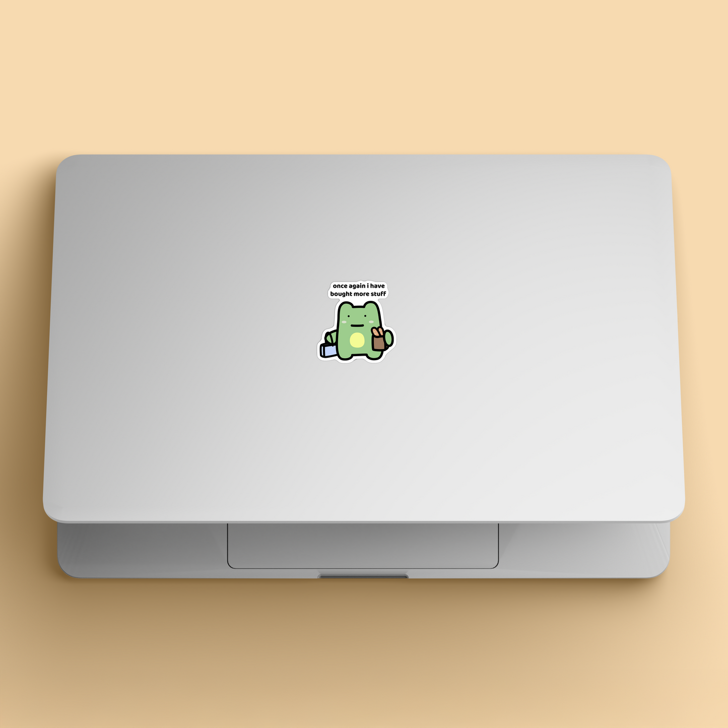 waterproof frog vinyl sticker with the text "Once again i have bought more stuff" on a laptop