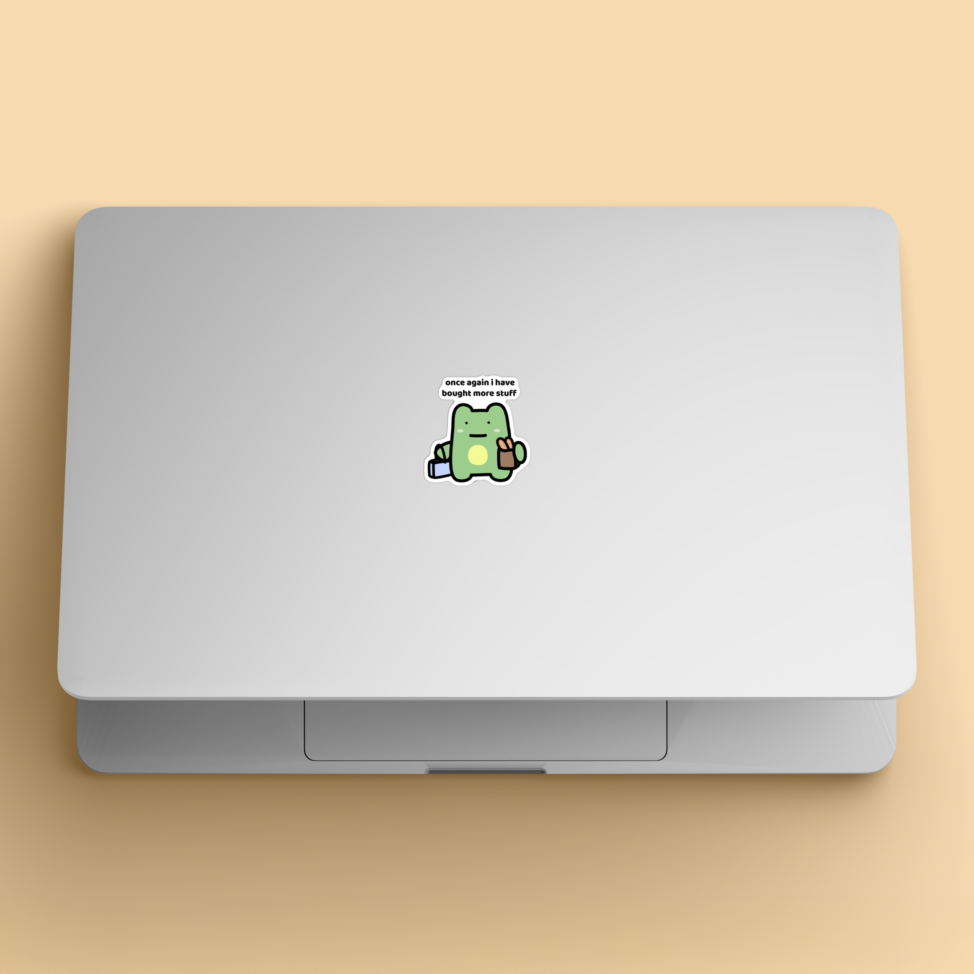 waterproof frog vinyl sticker with the text "Once again i have bought more stuff" on a laptop