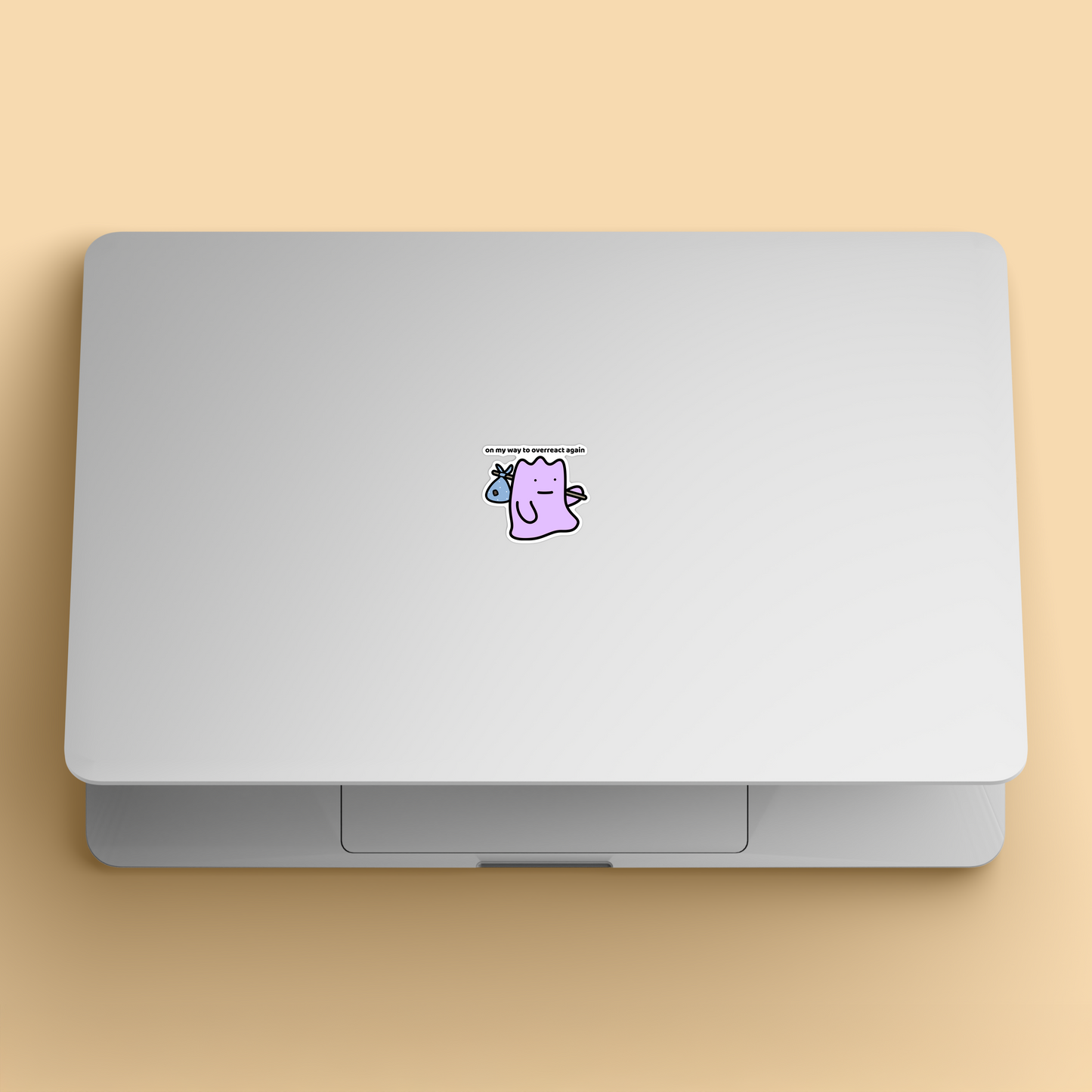 waterproof vinyl sticker with the text “On my way to overreact again" on a laptop