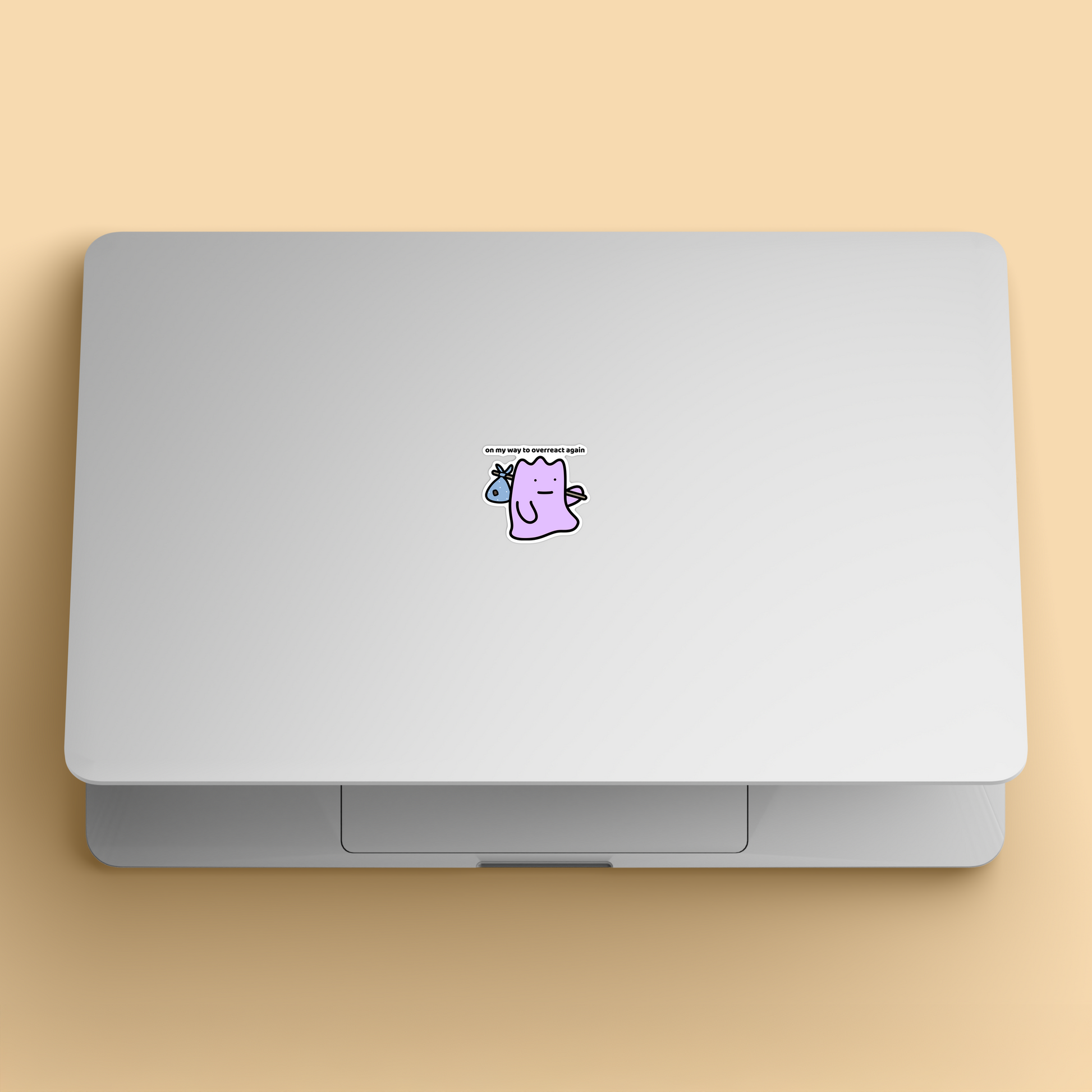 waterproof vinyl sticker with the text “On my way to overreact again" on a laptop