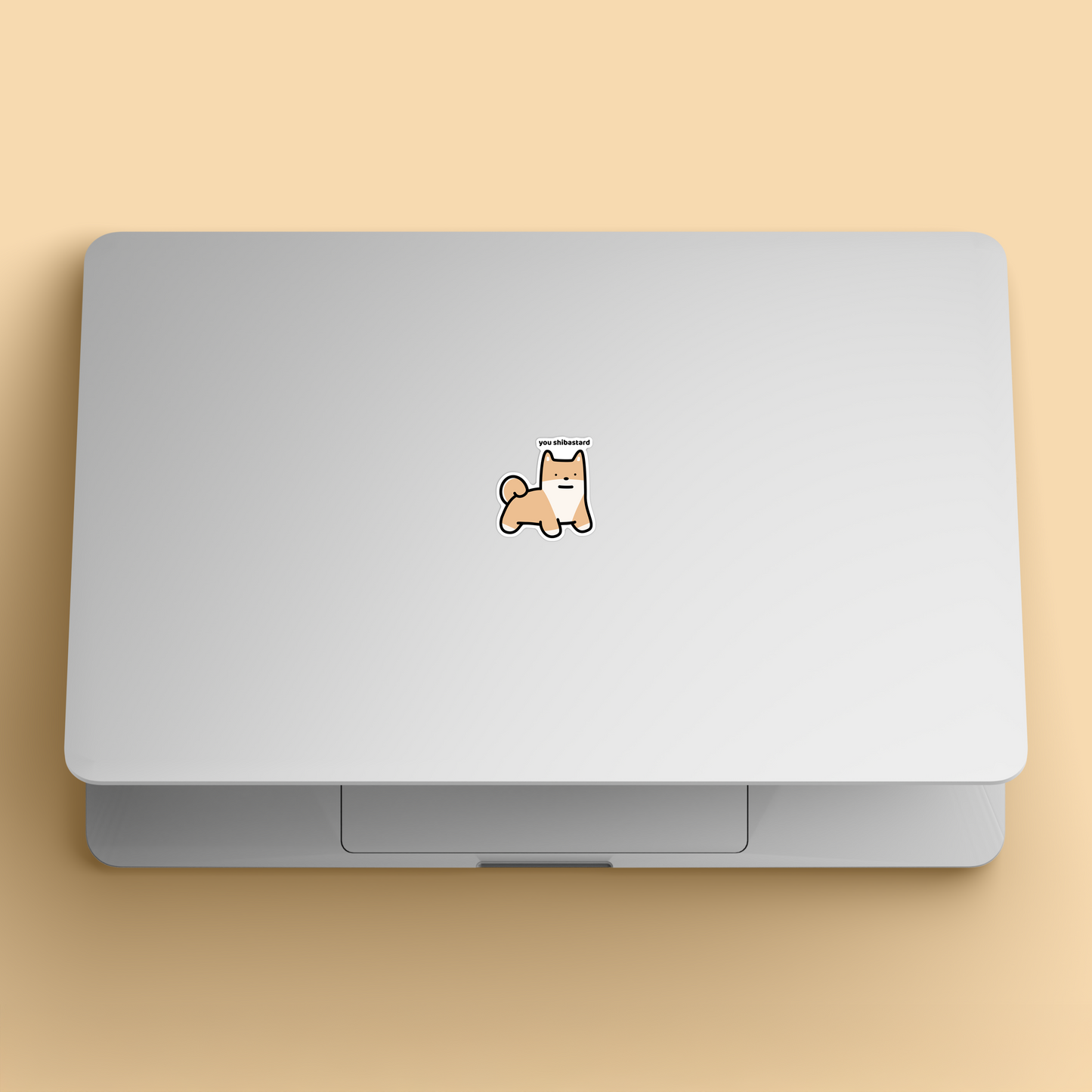 waterproof shiba vinyl sticker with the text "You shibastard" on a laptop