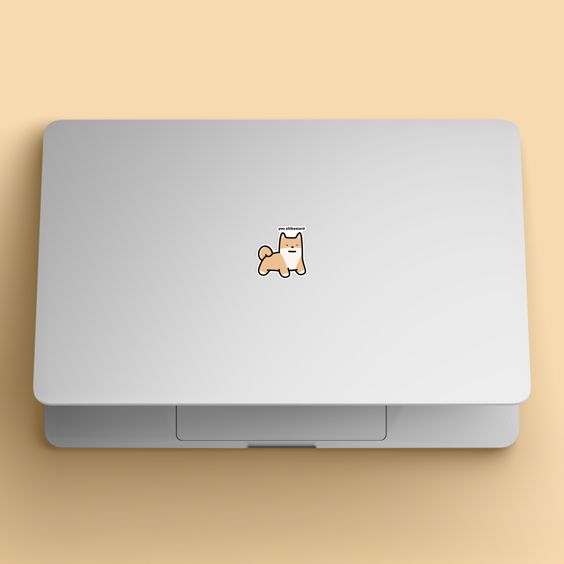 waterproof shiba vinyl sticker with the text "You shibastard" on a laptop